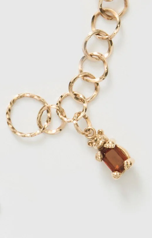 Gold necklace with a bear charm detail