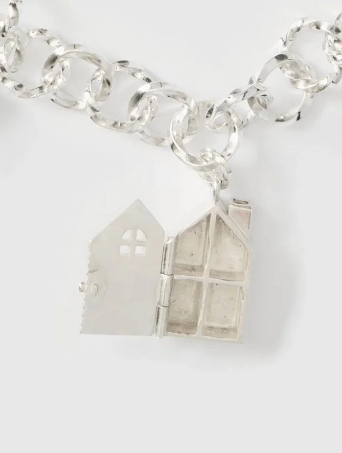 Miniature silver dollhouse charm opened to reveal the interior