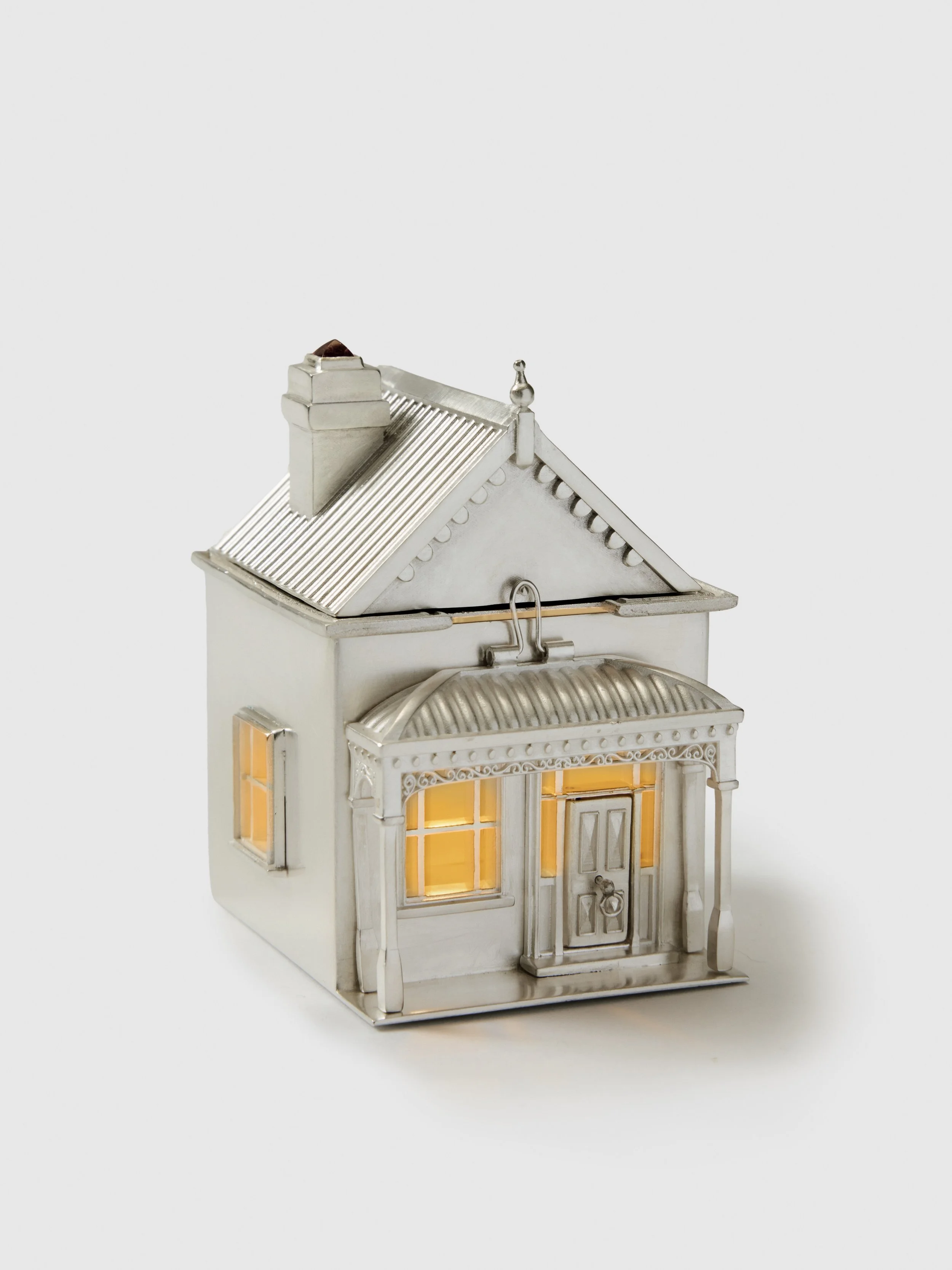 Silver house jewellery piece photographed in dramatic studio lighting